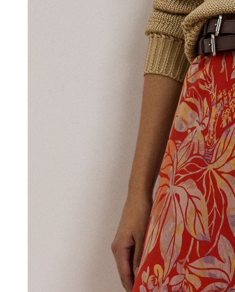 Crafted from airy crinkle georgette, this A-line midi skirt displays a painterly floral motif against a vibrant red backdrop.