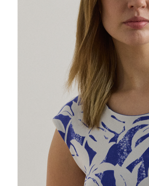 Crafted with smooth stretch jersey for a soft hand and fluid drape, this cap-sleeve dress depicts a palm-frond print in hues of white and blue.