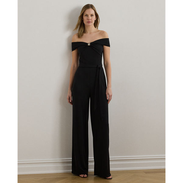 Crafted with smooth stretch jersey, this wide-leg jumpsuit embodies modern elegance with an off-the-shoulder neckline that gathers into a textured, bamboo-inspired embellishment at the front. A self-belt at the waist completes the look.