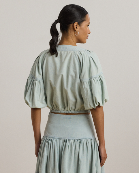 Crafted with lightweight cotton chambray, this effortless cropped blouse features voluminous bubble sleeves and an elasticised drawcord waist for a blouson effect.