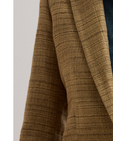 A wardrobe essential, this blazer is rendered in textured herringbone tweed spun with a lightweight blend that includes linen, cotton and silk. Shoulder pads, waist darts and panel seams heighten this style's refined sensibility.