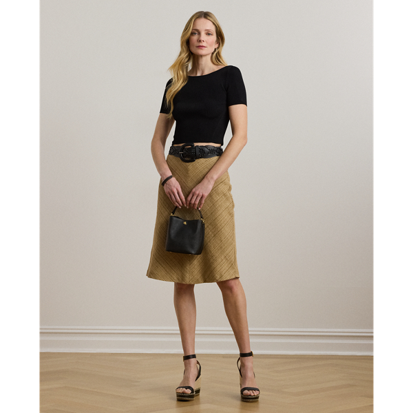 Crafted with lightweight linen-blend tweed, this midi skirt features an A-line silhouette enhanced with a herringbone pattern.