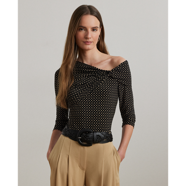 A twist-front accent beautifully complements the asymmetrical off-the-shoulder neckline of this top, which is crafted with stretch jersey for a comfortable feel. This version displays the season's two-tone geometric print.