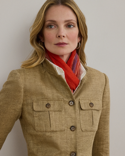 A sophisticated layer, this jacket unites a textured herringbone linen construction with surplus-inspired design elements, including a band collar, signature horn-effect buttons and box-pleated patch pockets.
