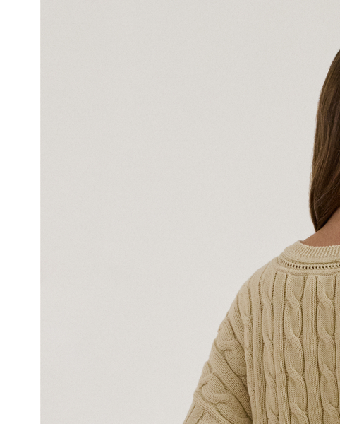 Crafted with ultrasoft combed cotton, this monochromatic version of Lauren  Ralph Lauren Lauren's iconic cricket jumper features a cable-knit body detailed with delicate pointelle stitching along the neckline.