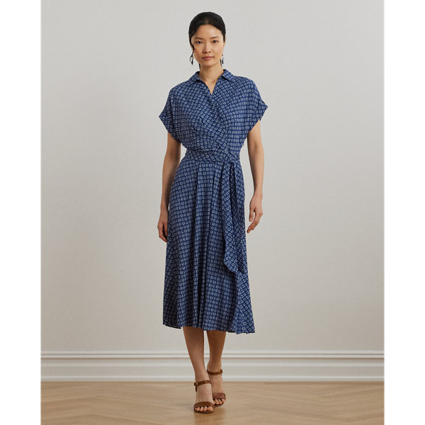 Crafted from airy crepe de Chine, this dress balances a spread collar and roll-tab sleeves with a feminine surplice neckline to create a look that is casual yet refined. Detailed with "LRL"-engraved buttons, this version displays the season's stylised geometric print.