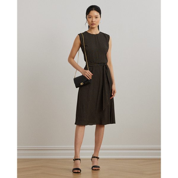 With cap sleeves and a waist-accentuating self-belt, this airy bubble crepe dress is updated for the season with a two-tone geometric print.