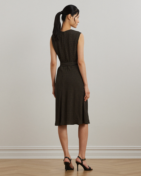 With cap sleeves and a waist-accentuating self-belt, this airy bubble crepe dress is updated for the season with a two-tone geometric print.