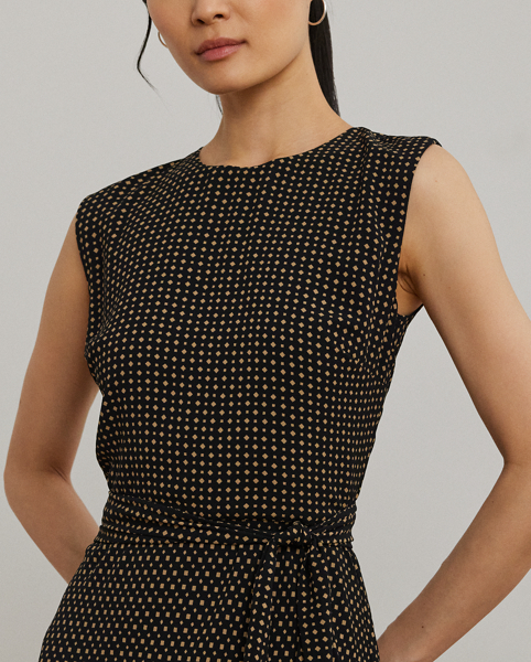With cap sleeves and a waist-accentuating self-belt, this airy bubble crepe dress is updated for the season with a two-tone geometric print.