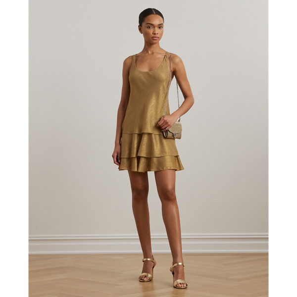 An enchanting addition to your dress collection, this sleeveless style unites a vintage-inspired shift silhouette with airy metallic chiffon and a tiered skirt, creating fluid movement with each step.