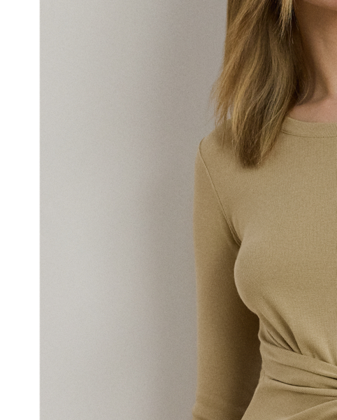 Rib-knit with a soft stretch-cotton blend, this long-sleeve crewneck dress is cut for a slim-fitting silhouette and a calf-grazing midi length. A tie-front design at the waist adds contemporary flare, while a skirt slit affords ease of movement.