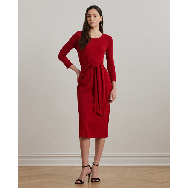 Rib-knit with a soft stretch-cotton blend, this long-sleeve crewneck dress is cut for a slim-fitting silhouette and a calf-grazing midi length. A tie-front design at the waist adds contemporary flare, while a skirt slit affords ease of movement.