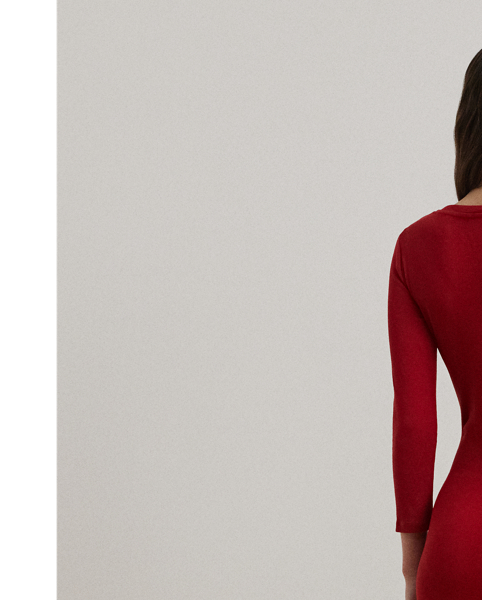 Rib-knit with a soft stretch-cotton blend, this long-sleeve crewneck dress is cut for a slim-fitting silhouette and a calf-grazing midi length. A tie-front design at the waist adds contemporary flare, while a skirt slit affords ease of movement.