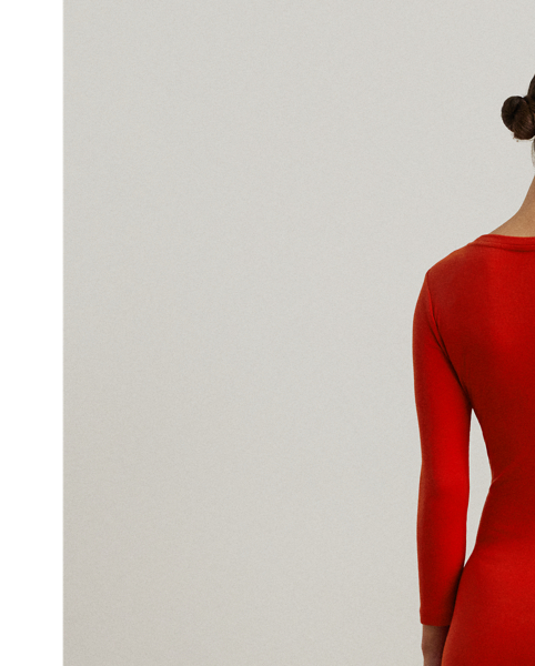 Rib-knit with a soft stretch-cotton blend, this long-sleeve crewneck dress is cut for a slim-fitting silhouette and a calf-grazing midi length. A tie-front design at the waist adds contemporary flare, while a skirt slit affords ease of movement.