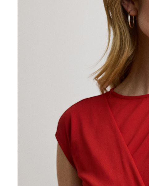 Rendered in smooth stretch jersey for ease of movement, this elegant cap-sleeve dress showcases a figure-skimming sheath silhouette and a pleated wrap-style overlay that gathers into a bamboo-inspired, textured metal O-ring at the waist.