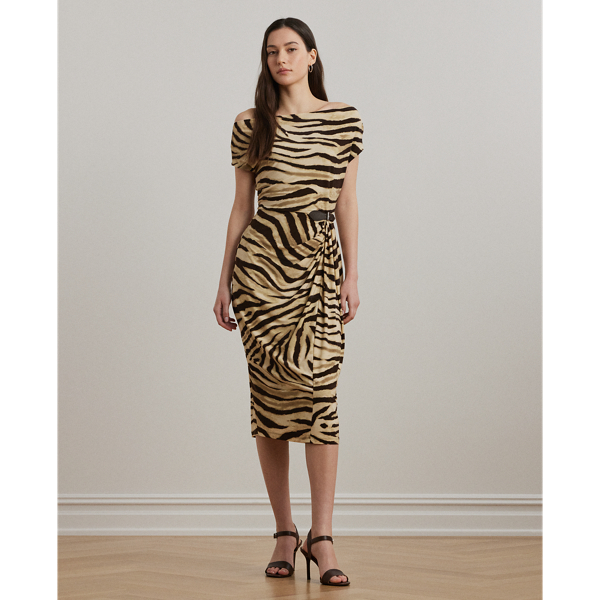Blending timeless elegance with modern design elements, this off-the-shoulder dress with asymmetrical sleeves is beautifully draped to create a pleated, sheath silhouette. Punctuated by a faux-leather buckled tab at the waist, this style is crafted with soft jersey showcasing the season's zebra print.