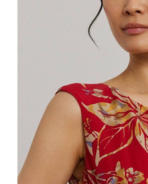 An eye-catching twist-front detail on the bodice serves as the focal point of this cap-sleeve dress, which is crafted from stretch-infused jersey for a soft feel and ease of movement. This version displays a painterly floral motif against a vibrant red backdrop.