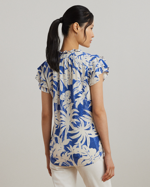 Crafted with lightweight linen-blend jersey, this tie-neck top is characterised by flutter sleeves, ruffle trim and the season's palm-frond print in hues of white and blue.