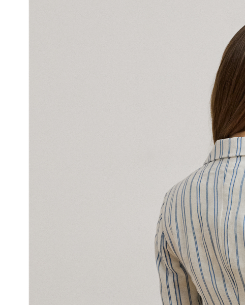 Yarn-dyed with variegated vertical stripes, this essential blazer is tailored with a lightweight linen blend for a polished look. Shoulder pads enhance its structured silhouette, while sartorial design elements – including notch lapels and waist darts – add a refined finish.