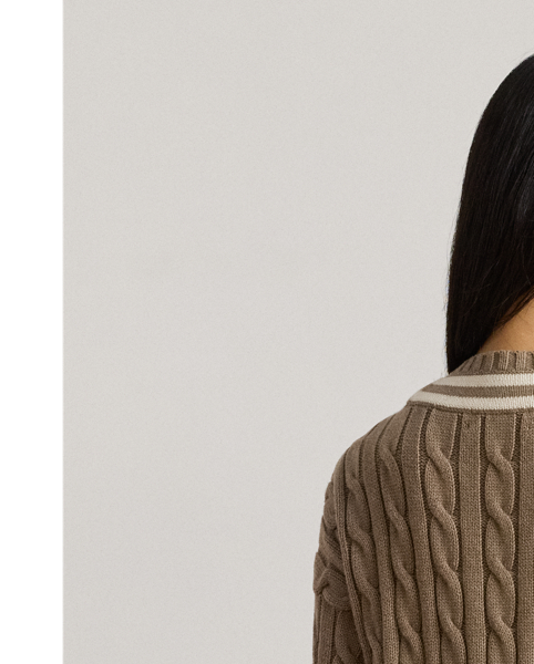 Distinguished by its contrast stripes and cable-knit pattern, this version of Lauren  Ralph Lauren Lauren's iconic cricket jumper is crafted with ultrasoft combed cotton. An "LRL"-embroidered logo on the hem completes the look.