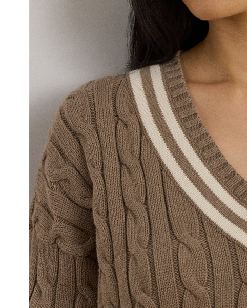 Distinguished by its contrast stripes and cable-knit pattern, this version of Lauren  Ralph Lauren Lauren's iconic cricket jumper is crafted with ultrasoft combed cotton. An "LRL"-embroidered logo on the hem completes the look.