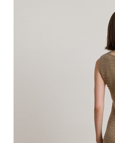 The slim-fitting silhouette of this sleeveless jumper dress is basket-woven with a wool blend, creating an inviting texture and a luxuriously soft hand feel.