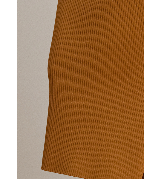 A rib-knit pattern brings subtle dimension to the pencil silhouette of this midi skirt, which is finished with a slit on the side seam for ease of movement.