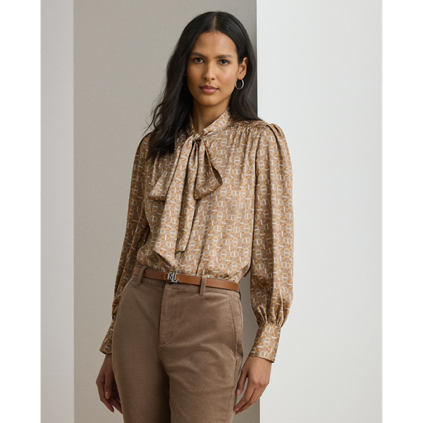 Silky twill brings a subtle sheen and graceful drape to this blouse, which is characterised by a voluminous tie-neck accent and blouson sleeves. This season's iteration showcases a stylised, equestrian-inspired geometric print.