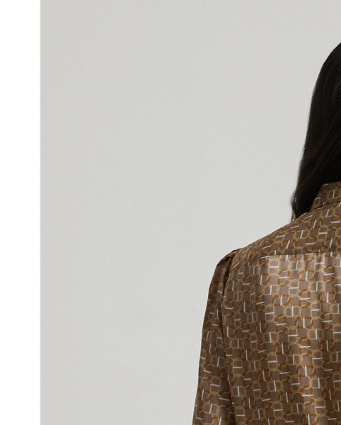 Silky twill brings a subtle sheen and graceful drape to this blouse, which is characterised by a voluminous tie-neck accent and blouson sleeves. This season's iteration showcases a stylised, equestrian-inspired geometric print.