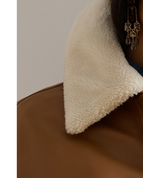 This luxurious take on the surplus-inspired bomber jacket features a lambskin leather shell and a removable, faux-shearling collar for versatile styling.