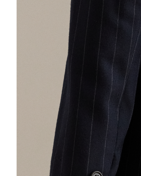Slender, yarn-dyed pinstripes punctuate the structured silhouette of this sophisticated double-breasted blazer, which is finished with peak lapels and signature horn-effect buttons.
