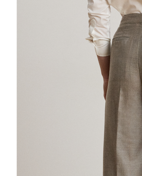 Crisp creases and pleats enhance the wide-leg silhouette of these trousers, which are crafted from wool herringbone twill for subtle texture and a refined sensibility. Displaying a subtle checked pattern, this style is finished with signature horn-effect buttons, waist darts and folded cuffs.