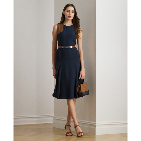 This refined sleeveless dress features fluid double-faced georgette and a sumptuous faux-leather shoulder patch.