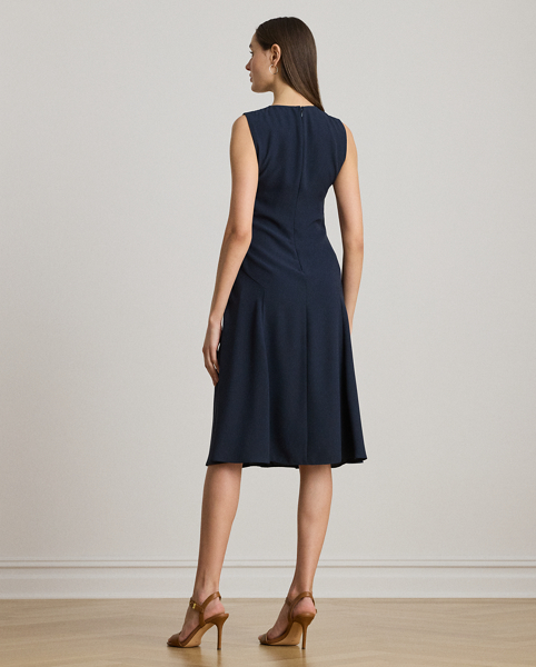 This refined sleeveless dress features fluid double-faced georgette and a sumptuous faux-leather shoulder patch.
