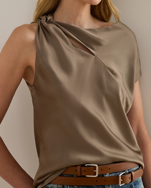 Beautifully draped in glossy satin charmeuse, this blouse features an asymmetrical design with one cap sleeve and a twisted strap. A keyhole detail and pleats at the strap complete the look.