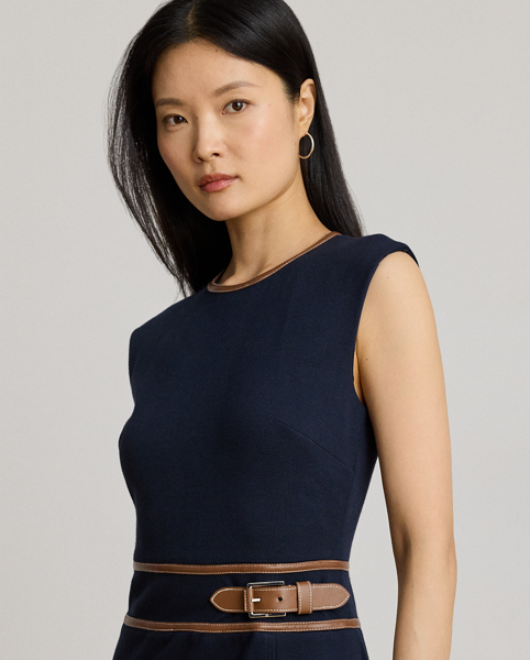 This refined cap-sleeve dress features a faux-leather buckled tab at the waist and a sheath silhouette rendered in stretch-infused, textured herringbone jacquard. A slit in the skirt offers ease of movement.