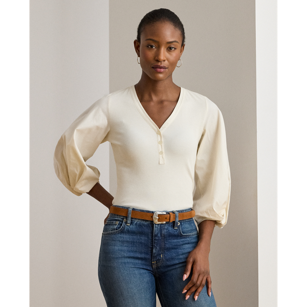 Rib-knit with a soft cotton blend for subtle texture, this top pairs a casual Henley design with voluminous balloon sleeves for a feminine twist.