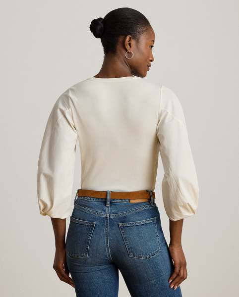 Rib-knit with a soft cotton blend for subtle texture, this top pairs a casual Henley design with voluminous balloon sleeves for a feminine twist.