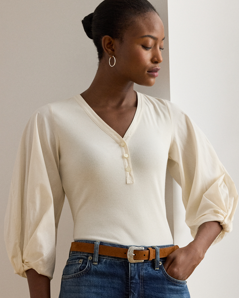 Rib-knit with a soft cotton blend for subtle texture, this top pairs a casual Henley design with voluminous balloon sleeves for a feminine twist.