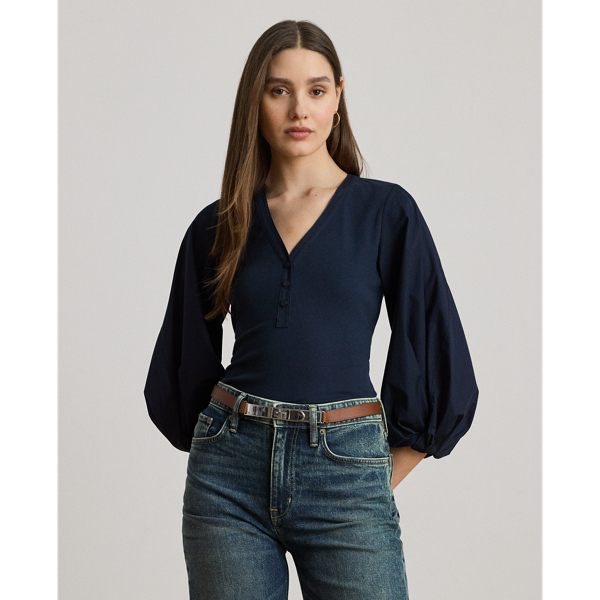 Rib-knit with a soft cotton blend for subtle texture, this top pairs a casual Henley design with voluminous balloon sleeves for a feminine twist.
