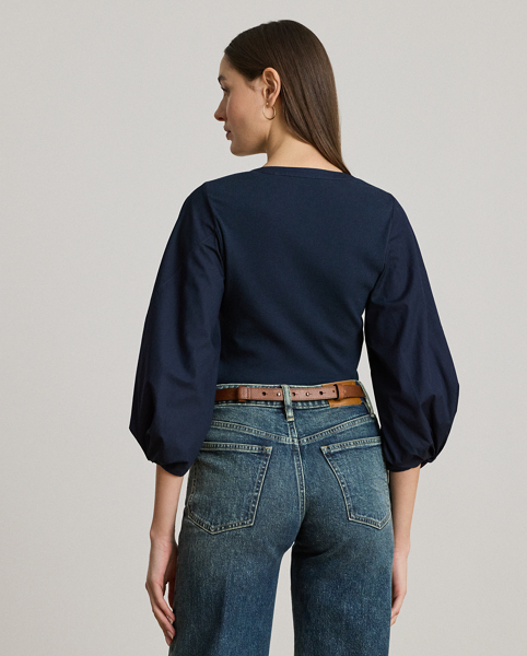 Rib-knit with a soft cotton blend for subtle texture, this top pairs a casual Henley design with voluminous balloon sleeves for a feminine twist.