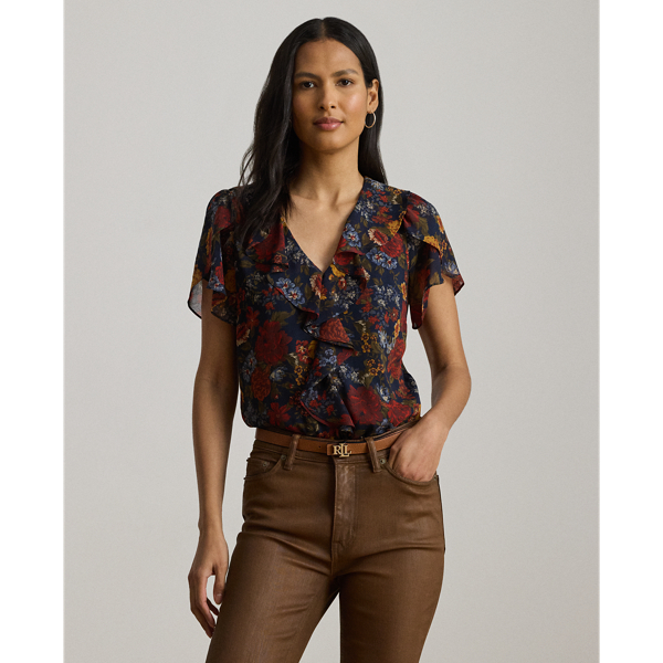 Undeniably romantic, this blouse unites airy georgette with ruffle trim and flutter tulip sleeves. This version depicts the season's painterly florals against a navy backdrop.