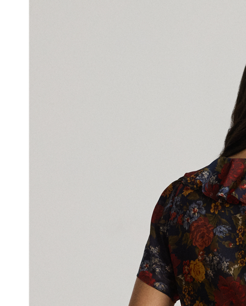 Undeniably romantic, this blouse unites airy georgette with ruffle trim and flutter tulip sleeves. This version depicts the season's painterly florals against a navy backdrop.