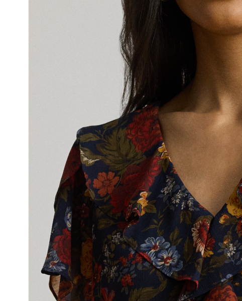Undeniably romantic, this blouse unites airy georgette with ruffle trim and flutter tulip sleeves. This version depicts the season's painterly florals against a navy backdrop.