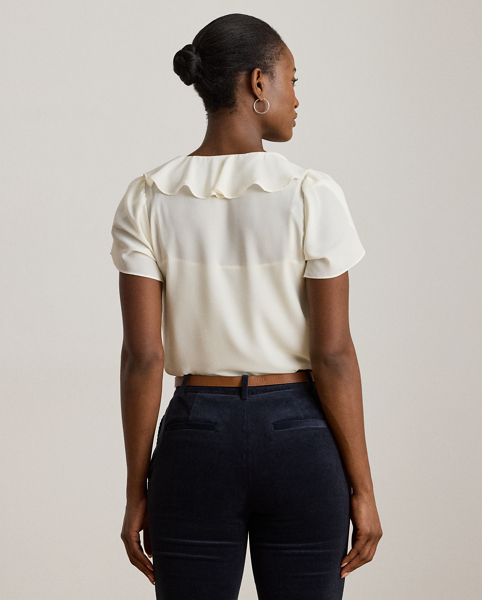 Undeniably romantic, this blouse combines airy georgette with ruffle trim and flutter tulip sleeves.