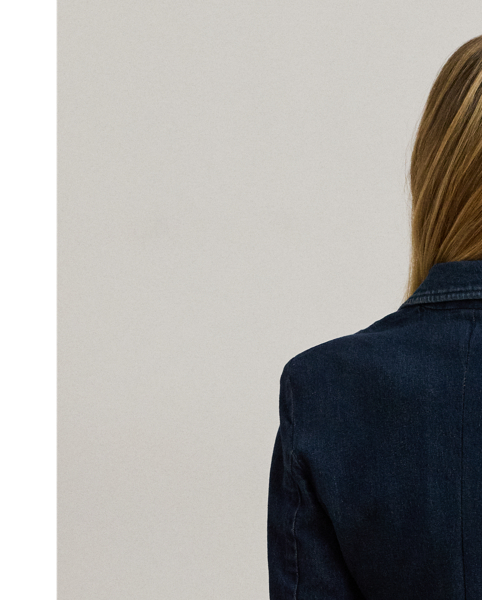 Featuring a streamlined silhouette enhanced with shoulder pads and waist darts, this blazer combines the casual appeal of dark-wash denim with the sophistication of sartorial details.
