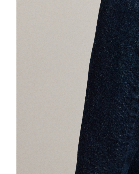 Featuring a streamlined silhouette enhanced with shoulder pads and waist darts, this blazer combines the casual appeal of dark-wash denim with the sophistication of sartorial details.