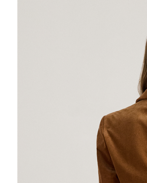 Fine-wale corduroy brings subtle texture and a velvety hand to the structured silhouette of this double-breasted blazer, which is finished with peak lapels and signature horn-effect buttons.