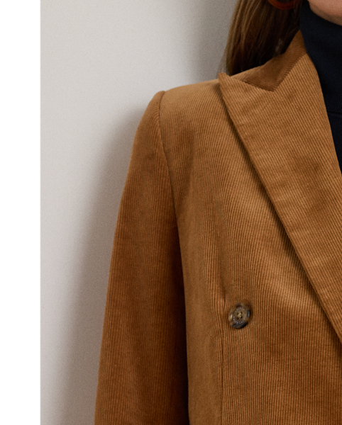 Fine-wale corduroy brings subtle texture and a velvety hand to the structured silhouette of this double-breasted blazer, which is finished with peak lapels and signature horn-effect buttons.