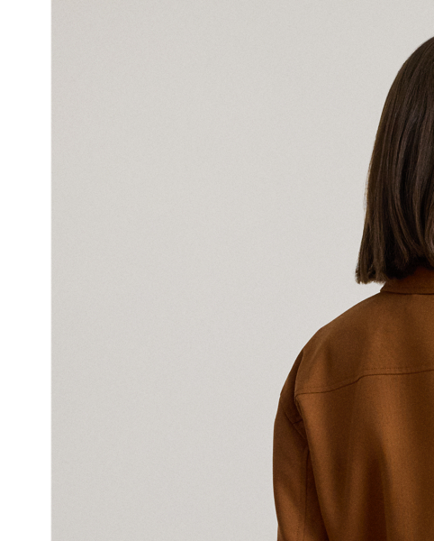 Tailored from soft wool-blend serge, this cropped jacket showcases surplus-inspired, faux-leather buckled tabs and patch pockets. Signature horn-effect buttons complete the look.